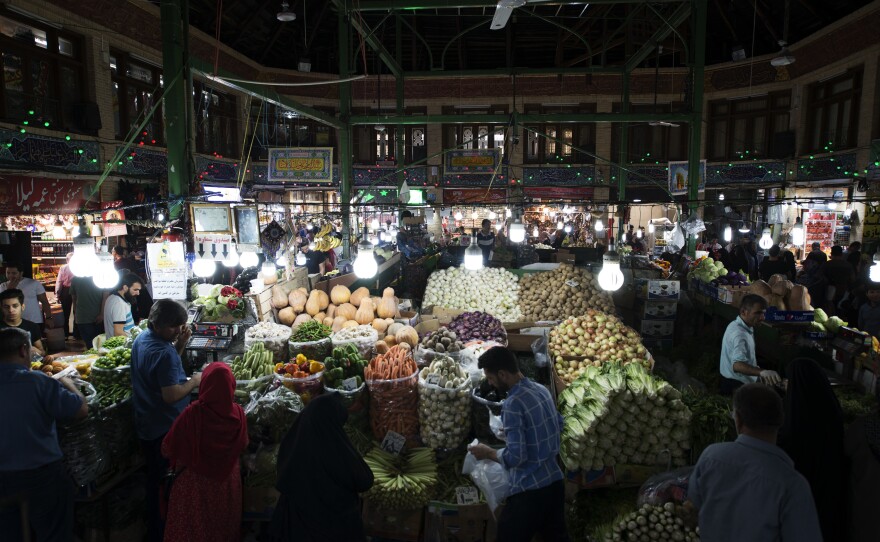People shop in Tehran's Tajrish market. Iran faces high inflation. Food prices went up by more than 70% between July 2018 and July 2019, one economy expert says.