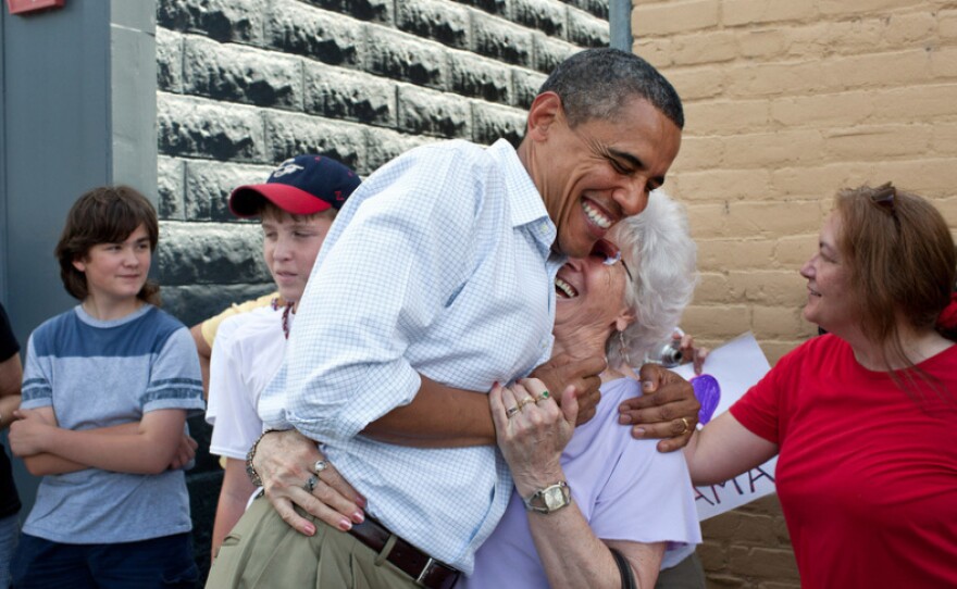 <p>President Barack Obama greets people outside the Old Market Deli in Cannon Falls, Minn., on the Aug. 15, during a Midwest bus tour. The same day he said he likes the term "Obamacare."</p>