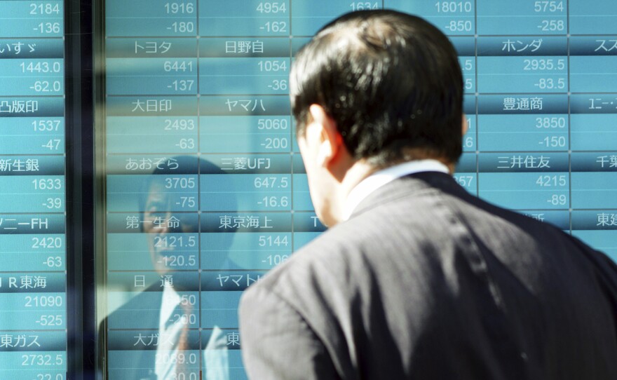 A man looks at an electronic stock board showing Japan's Nikkei 225 index on Thursday in Tokyo.