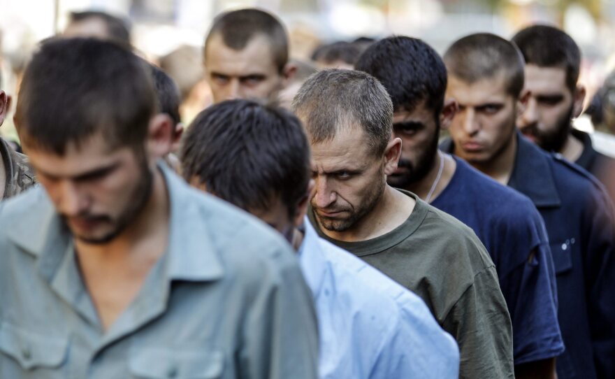 Ukrainian army prisoners of war are marched through  rebel-held Donetsk, Ukraine, in a counter-move to a parade in Kiev to mark the country's independence day.