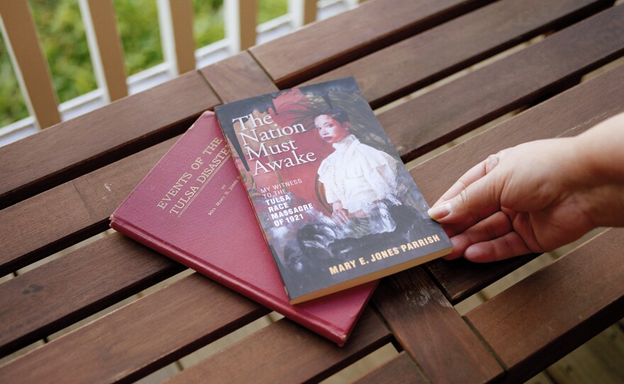 Copies of the original book, <em>Events of the Tulsa Disaster,</em> and the newly published version, <em>The Nation Must Awake</em>, written by Mary E. Jones Parrish, sit on Bruner's porch.
