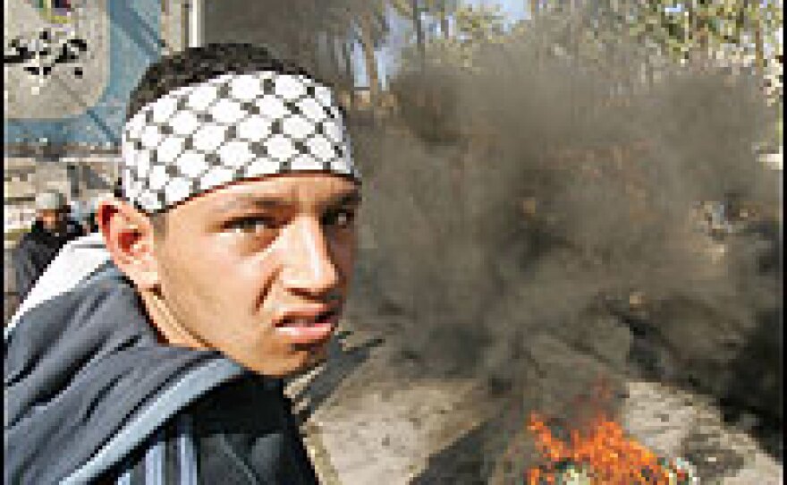 A supporter of the Fatah movement watches protests Saturday in the Gaza Strip town of Deir al-Balah.