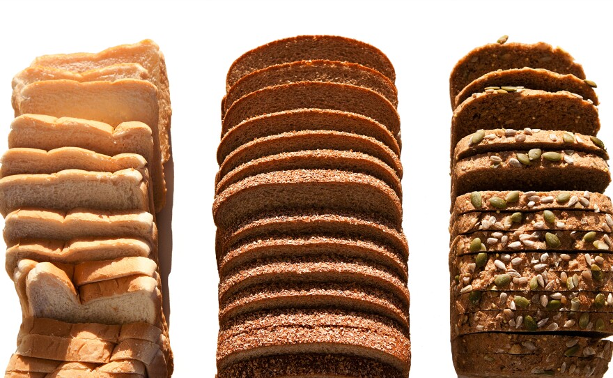 The most healthful loaves of bread contain chunks of grain still intact, like the seeded loaf on the right. Whole wheat loaves, like the one in the middle, may contain few whole grains and may be made up mostly of refined flour, like the white bread on the left.