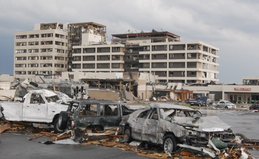 Damaged vehicles litter the parking lot of St. John's Regional Medical Center in Joplin, Mo., after a tornado hit the southwest Missouri city Sunday evening.