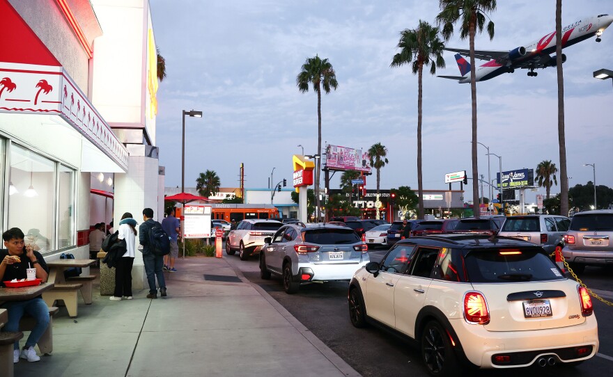A Delta Airlines plane lands near an In-N-Out Burger next to Los Angeles International Airport on Thursday.