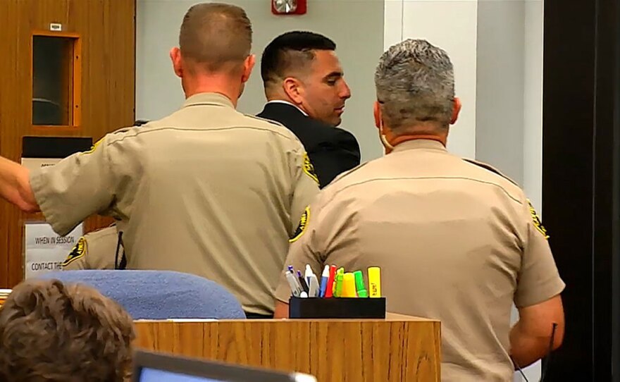 Sheriff's Deputy Richard Fischer is escorted in handcuffs from his arraignment at the San Diego Superior Court in Vista, Ca., Feb. 22, 2018.