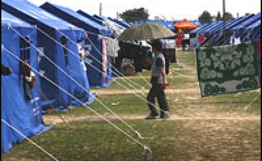 A person walks through the area that has become a tent city in Mianzhu, China.