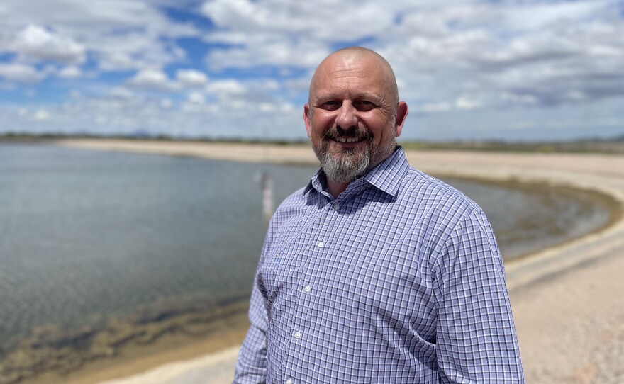 Tucson's water director John Kmiec stands next to a basin of Colorado River water.