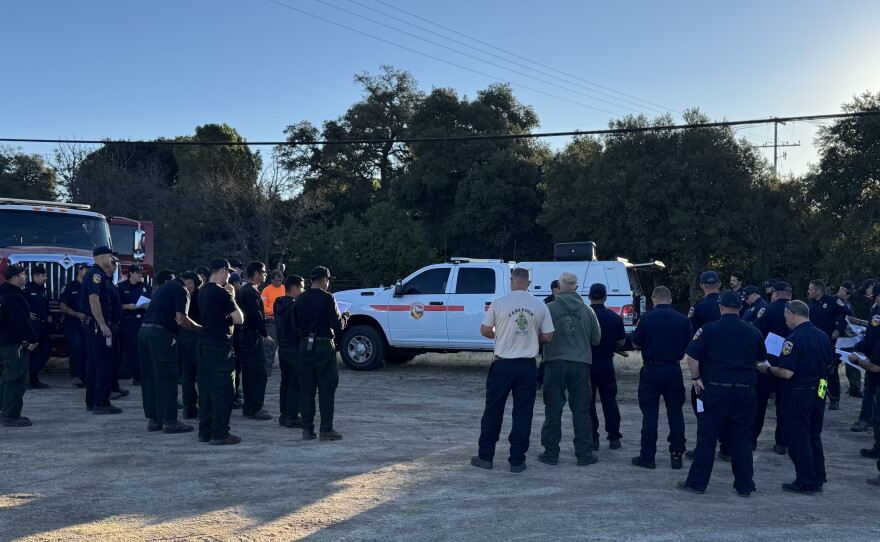 A briefing is being held at the ICP before crews continue to extinguish hot spots on Aug. 18, 2026.