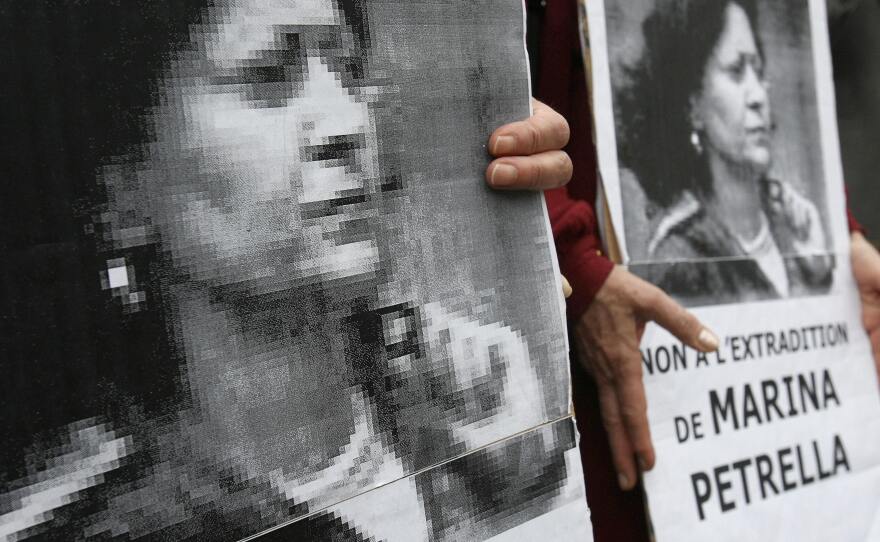 In 2008, people hold portraits of a former member of Italy's disbanded Red Brigades group Marina Petrella as they take part in a rally in Paris against her extradition to Italy. Petrella is one of seven individuals whose arrest in France was announced Wednesday.