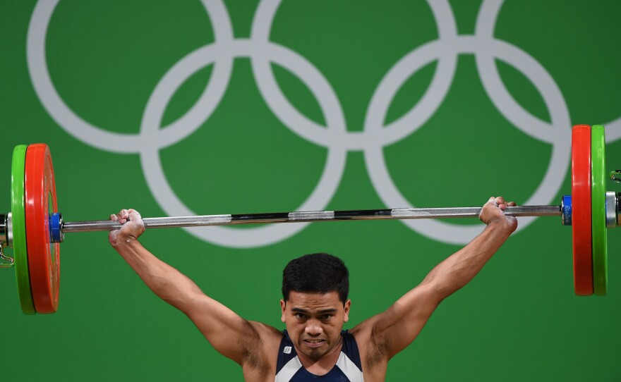 Nauru's Elson Brechtefeld competes during the men's 56kg weightlifting event on Aug. 7.