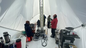 Inside of the Blue Ice Drill tent, drillers Tanner Kuhl (left) and Elizabeth Morton (right) work with graduate students Austin Carter, Jacob Morgan and postdoctoral fellow Sarah Shackleton in Antarctica in 2019.