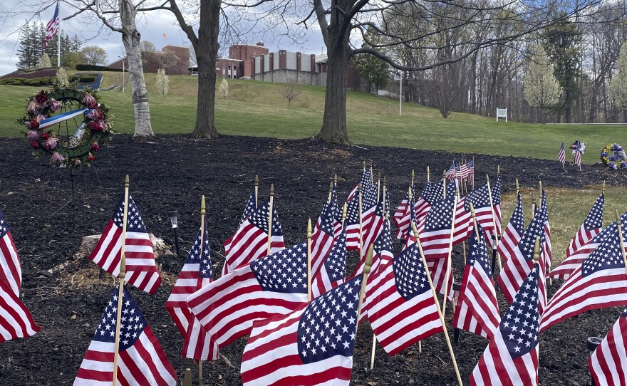 Flags and wreaths honor veterans on April 28, on the grounds of the Soldiers' Home in Holyoke, Mass., where a number of people died due to the coronavirus. While the death toll at the state-run Holyoke Soldiers' Home continues to climb, federal officials are investigating whether residents were denied proper medical care while the state's top prosecutor is deciding whether to bring legal action.