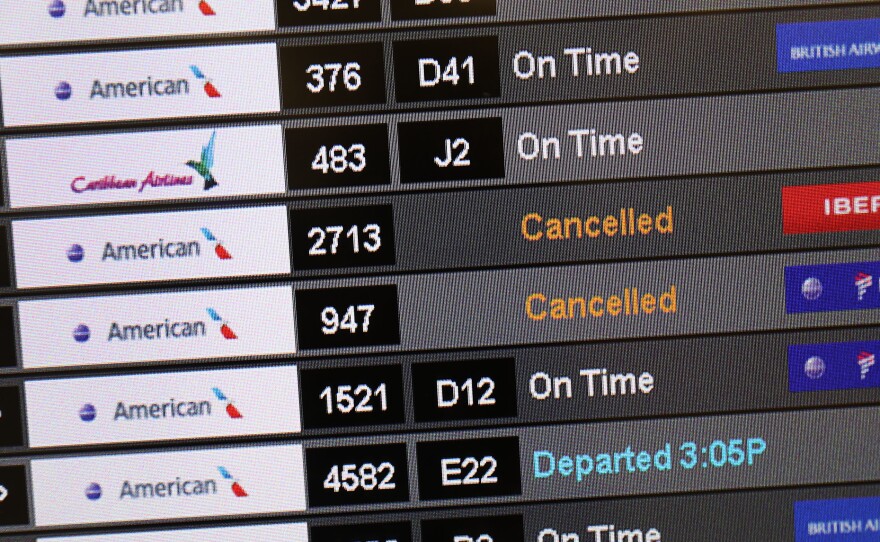 A sign at the Miami International Airport shows cancelled flights after American Airlines initially grounded its Boeing 737 Max  planes in March.