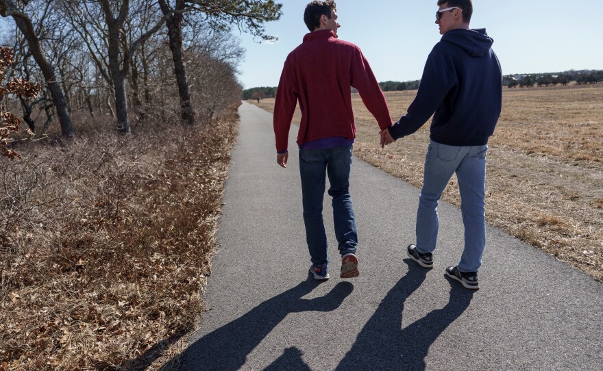 Twin brothers Sam and John take a walk outside their family home on Martha's Vineyard.