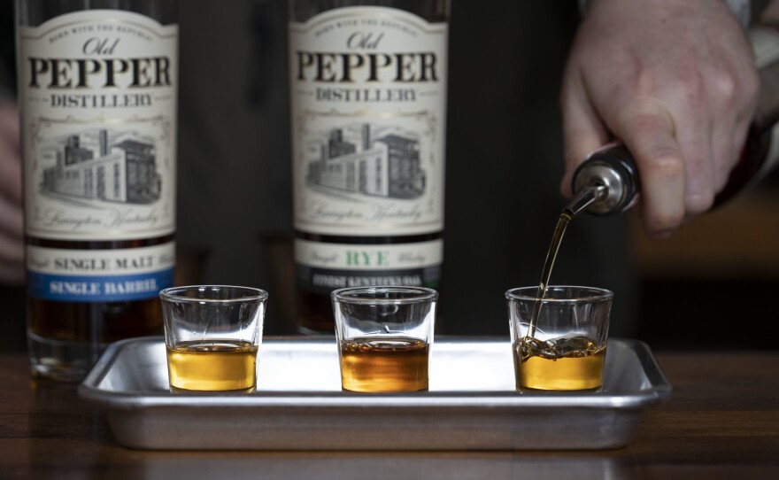Travis Kitchens pours a tasting flight at the James E. Pepper Distillery.