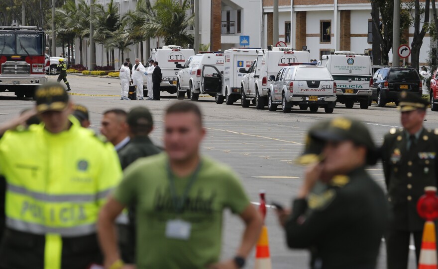 Forensic workers gather at the scene of a deadly car bombing at a police academy in Bogotá, Colombia, on Thursday.