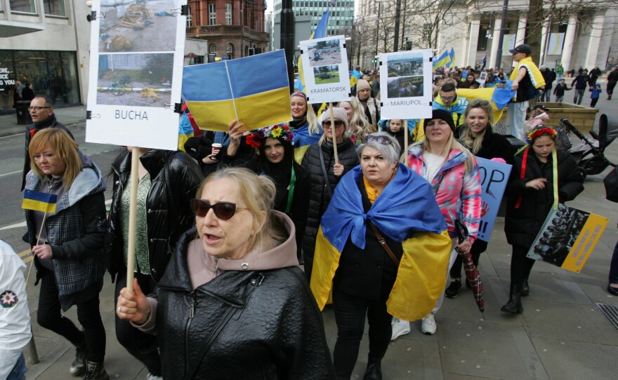 Ukrainian protesters in Manchester, England, hold placards on April 9 showing atrocities in Ukraine since the Russian invasion of the country.