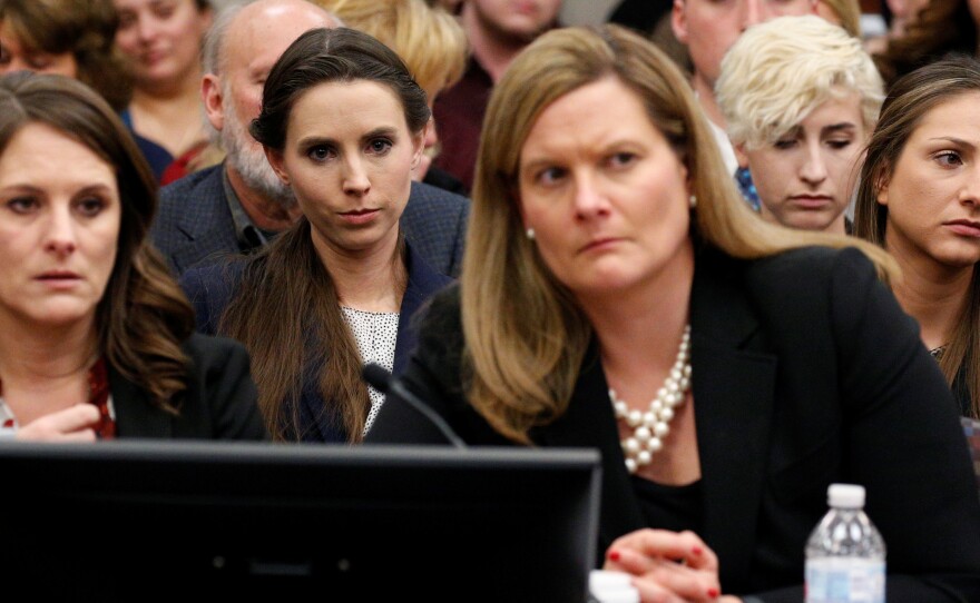 The entire USA Gymnastics board will resign, the group says. Rachael Denhollander (center) listens as Larry Nassar, a former team USA Gymnastics doctor, was sentenced to up to 175 years in prison for sexual abuse over decades of his involvement with the program.