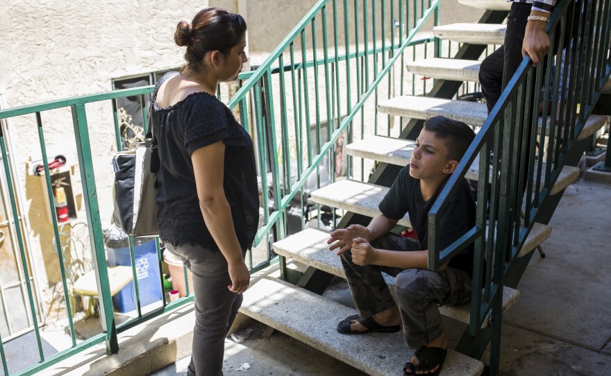Merdin Mohammed, the outreach director for City Heights Prep Charter School, visits a student’s home on June 27, 2017 in an attempt to enroll his siblings for the current school year.