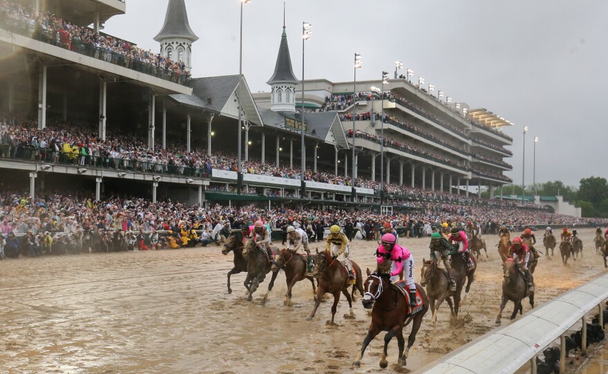 Riders cross the finish line at the 145th running of the Kentucky Derby at Churchill Downs last year.