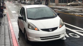 A car is parked in a red zone on J Street blocking newly installed bike lanes in downtown San Diego, Dec. 31 2018.