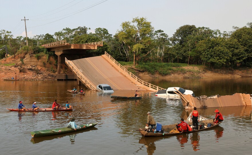 Local people and rescue workers navigate boats in the Curuca River after a bridge collapsed on the BR-319 highway in Careiro da Várzea, near Manaus, on Sept. 28.