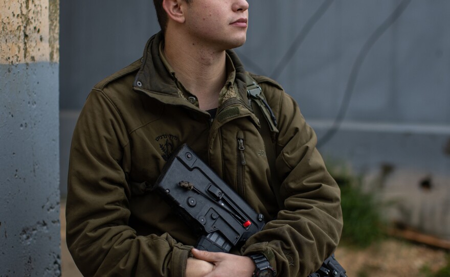 Max Sherman, an Israeli military reservist, sits for a portrait at a military base near the border with Lebanon in northern Israel.