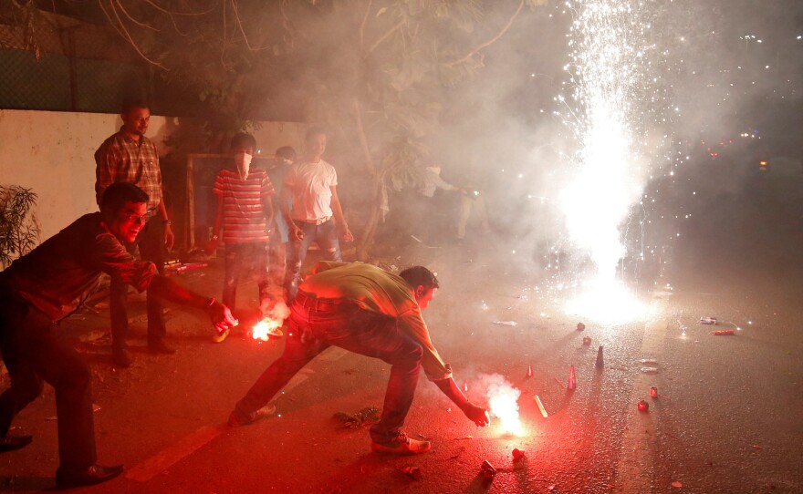 The fireworks of Diwali, the Hindu festival of lights, add smoke to the already polluted skies — and raise concern about the impact of all that pollution on coronavirus cases. This photo was taken in Ahmedabad, India, in 2019.