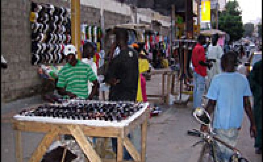 Street vendors, known as "bana bana," hawk goods in downtown Dakar, Senegal.