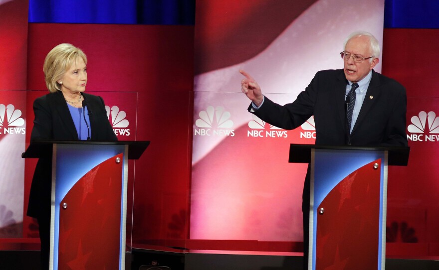 Democratic presidential candidate, Sen. Bernie Sanders, I-Vt., gestures towards Democratic presidential candidate, Hillary Clinton during the NBC, YouTube Democratic presidential debate in Charleston, S.C., on Sunday.