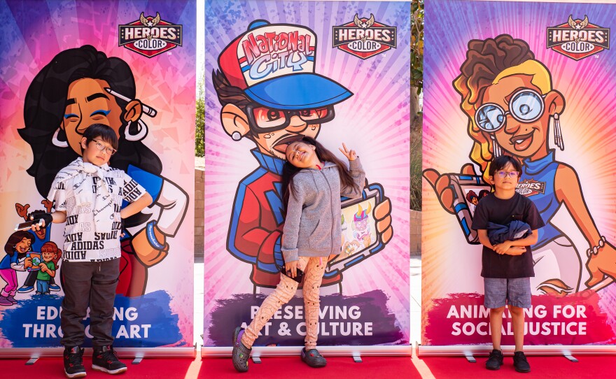 Students stand front of animated banners during 2023's first annual Elementary School Animation Film Festival in this undated image.