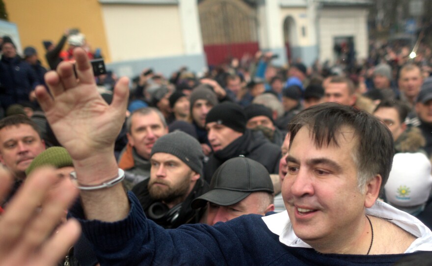 Former Georgian President Mikhail Saakashvili (center) greets his supporters after escaping a van headed for jail in Kiev on Tuesday.