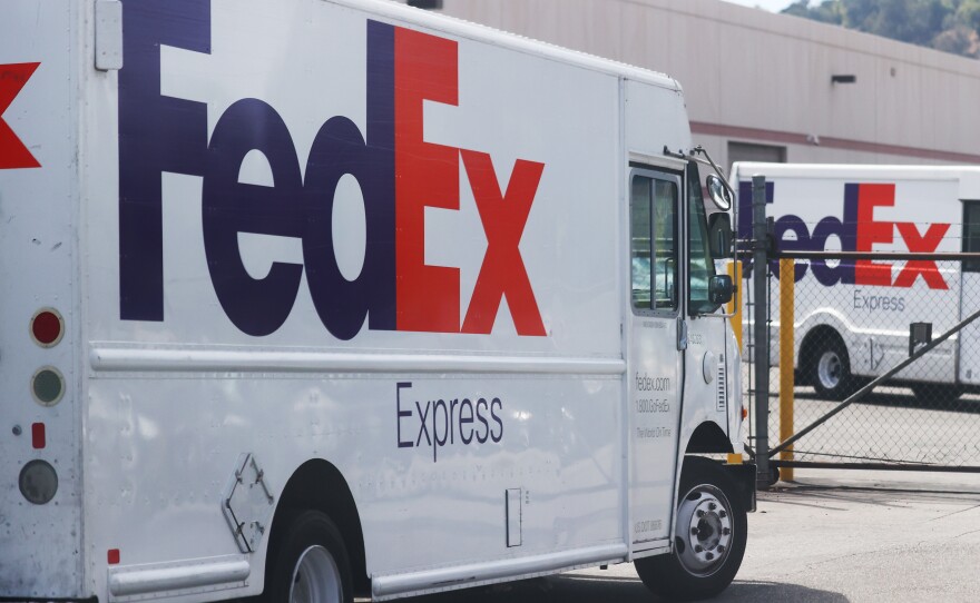 FedEx trucks are parked at a FedEx Ship Center on September 22, 2021 in Los Angeles, California. FedEx says the driver who dumped packages into an Alabama ravine at least six times is no longer with the company.