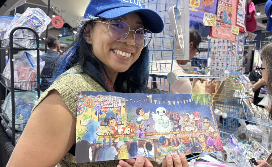 Genevieve Santos poses for a photo while holding up the print she created with Patrick Ballesteros on July 23, 2026.