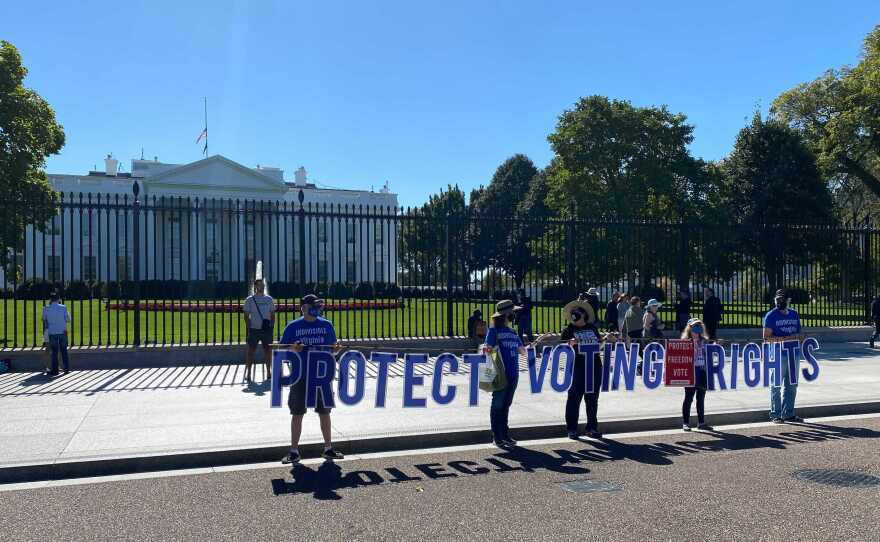 Voting rights activists demonstrate outside the White House on Tuesday. Many of them have been frustrated that President Biden hasn't more forcefully advocated for voting rights legislation.