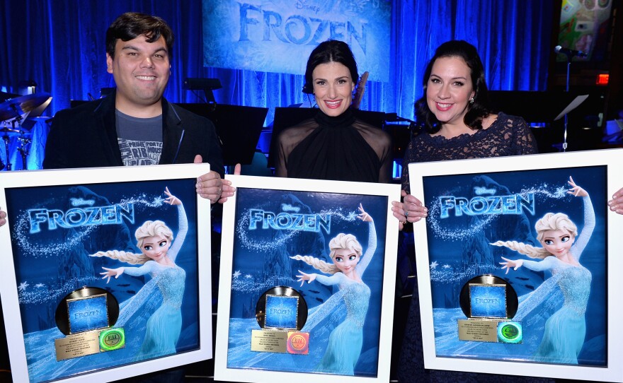 Singer Idina Menzel (center) and Frozen songwriters Bobby Lopez (left) and Kristen Anderson-Lopez pose with gold records in February. Since then, the movie's soundtrack has sold over 1.5 million more copies.