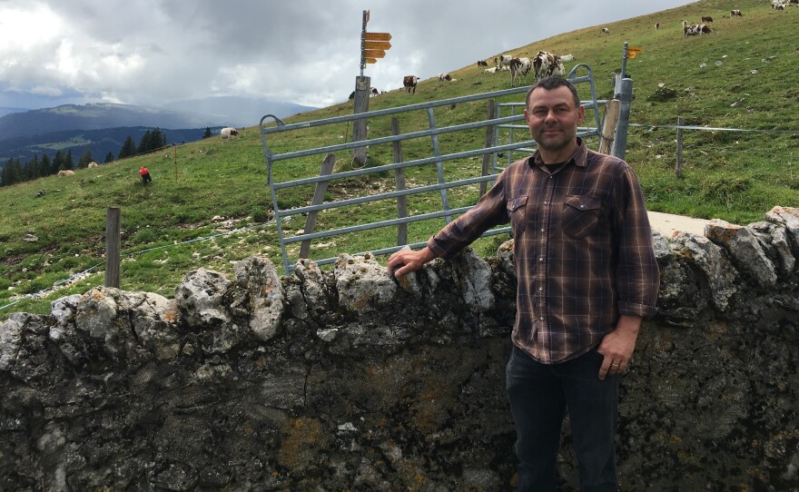 Dairy farmer Dominique Rochat says the Swiss government's water deliveries have allowed him to keep his cows in the high mountains.