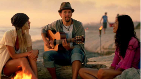 Musician Jason Mraz appears in a television commercial promoting travel to California. He's posing in front of a San Diego fire pit.