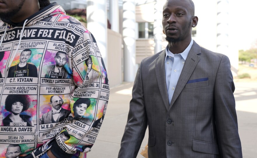 Michael Corey Jenkins, right, follows a friend as he enters the federal courthouse in Jackson, Miss., Wednesday, for sentencing on the third of the six former Rankin County law enforcement officers who committed racially motivated, violent torture on him and his friend Eddie Terrell Parker in 2023. The six former law officers pleaded guilty to torturing them.