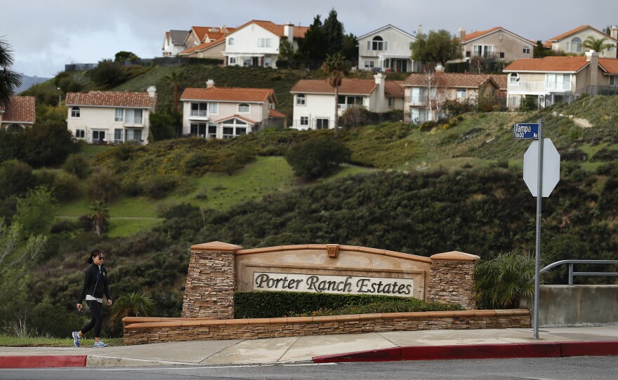 A woman walks to her home in Porter Ranch, Calif., last month, after state regulatory officials announced that SoCalGas Co.'s leaking well had finally been plugged.