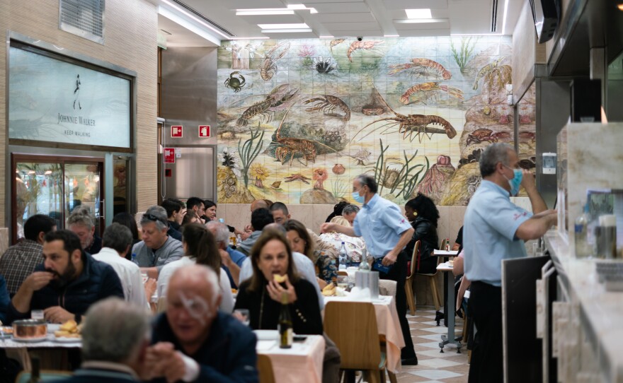 A crowded lunch scene at Cervejaria Ramiro, a popular seafood restaurant in Lisbon, Portugal.