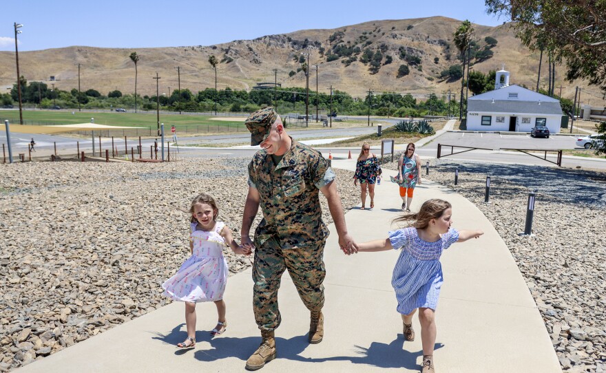 Hardebeck walks to his Purple Heart ceremony with his daughters Adalie and Zoey. He downplayed the incident for which he received the award for several years and only applied for it at the urging of Marines from that deployment.