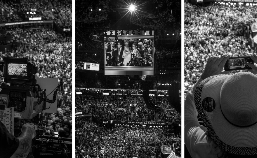 Attendees take in Wednesday evening's program at the convention hall through different screens.