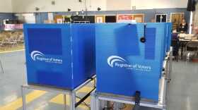 Blue voting booths are spread out inside a vote center in La Mesa Arts Academy, June 7, 2022.