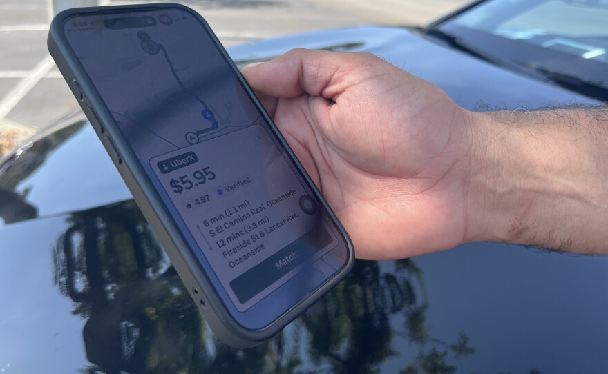 Rideshare driver and cofounder of San Diego Drivers United Librado Rivera shows the driver's view of a potential trip on Uber, Aug. 10, 2026.