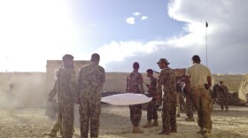 The body of an Afghan soldier is carried to an ambulance in eastern Afghanistan's Ghazni province. The soldier was shot while on guard duty at an Afghan army outpost near the U.S. base. He was brought to the Americans for medical treatment, but U.S. forces were unable to save him.