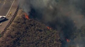 A burning vehicle ignited foliage alongside state Route 67 Friday afternoon, July 22, 2016. 