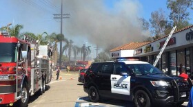 Escondido firefighters battling the blaze at a dry-cleaning business on Thursday, Aug. 28, 2019, where the roof collapsed during the fire, injuring a firefighter.	