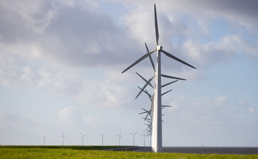 A new International Energy Agency report on climate change calls for halting approval of all new coal power plants this year. Here, wind turbines are seen on a dike near Urk, Netherlands, in January.